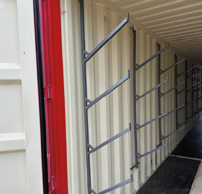 Racks can be added to the walls of a portable storage container to organize pipes, PVC or other long supplies. 