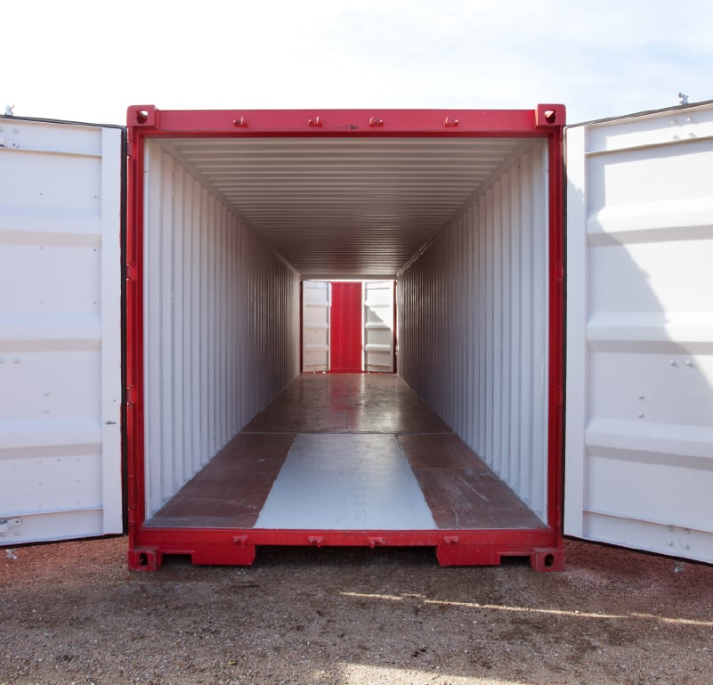 Interior view of a portable storage container with open cargo doors and steel walls.