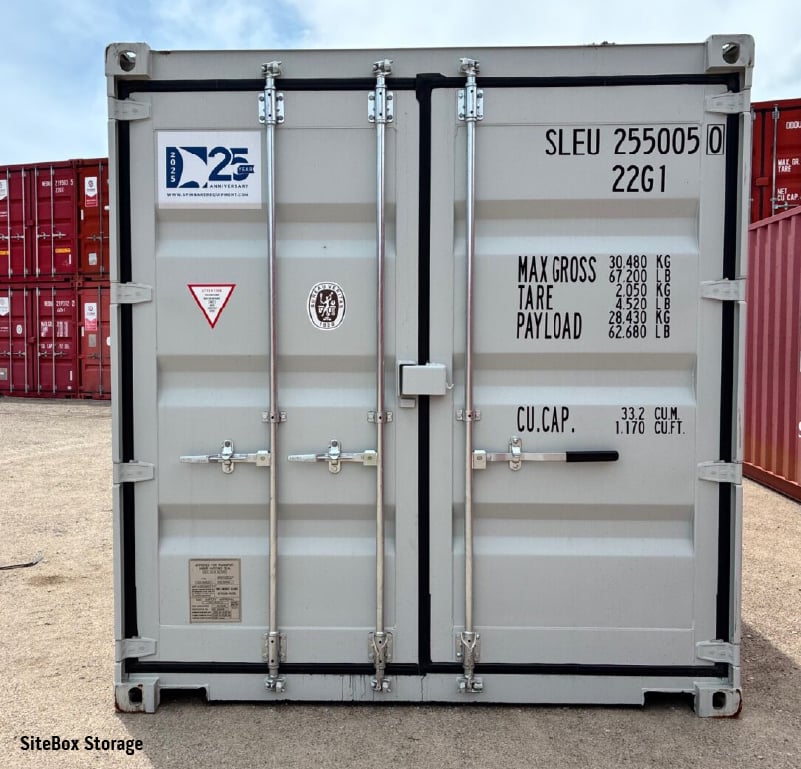 Used shipping container with closed cargo doors, locking bars and visible corner castings